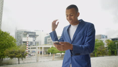 emotional young man during video call through smartphone.