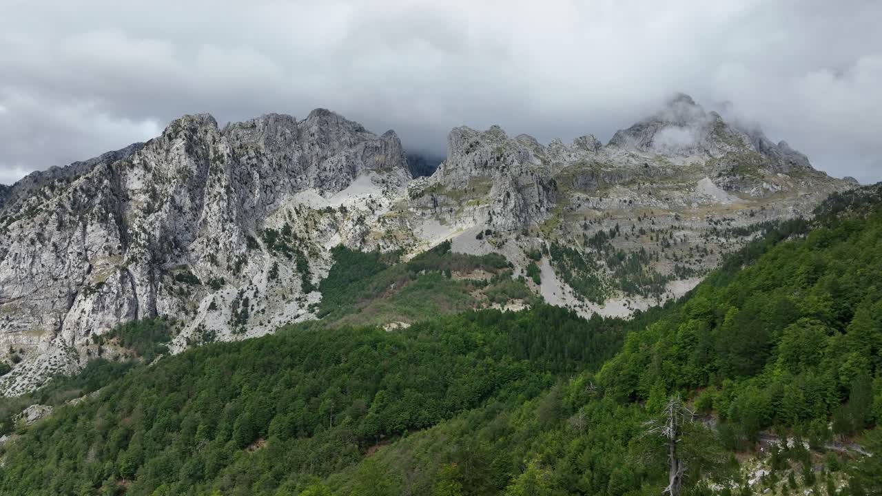 Rocky Mountain Range And Green Forest In Daytime In Theth, Shkoder County, Albania. - aerial shot