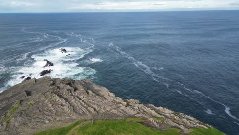 drone flying over irish rocky cliff of kilkee, county clare in ireland