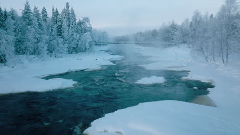 Flying-Through-The-River-With-Frigid-Weather-During-Winter-In-Vikaköngäs,-Lappi,-Finland