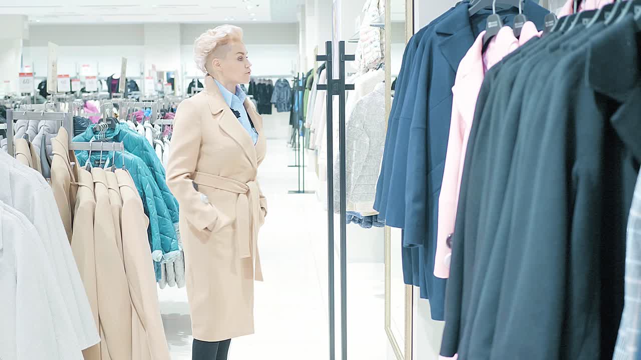 Woman Shopping for Coats in a Clothing Store