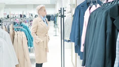woman shopping for coats in a clothing store