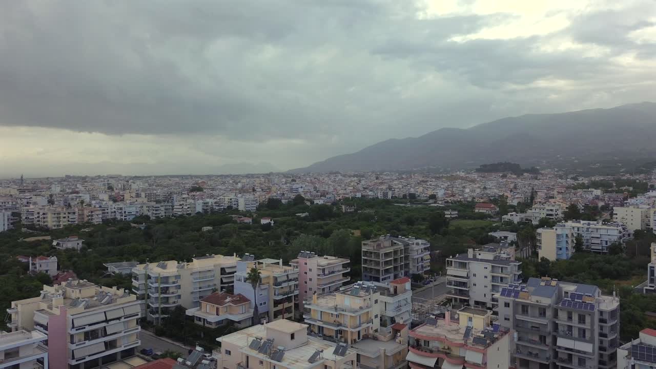 Aerial wide cityscape of view of Kalamata city on a cloudy afternoon, footage taken from east side suburbs 4K, right pan drone movement