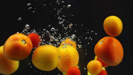 tomatoes splashing in water