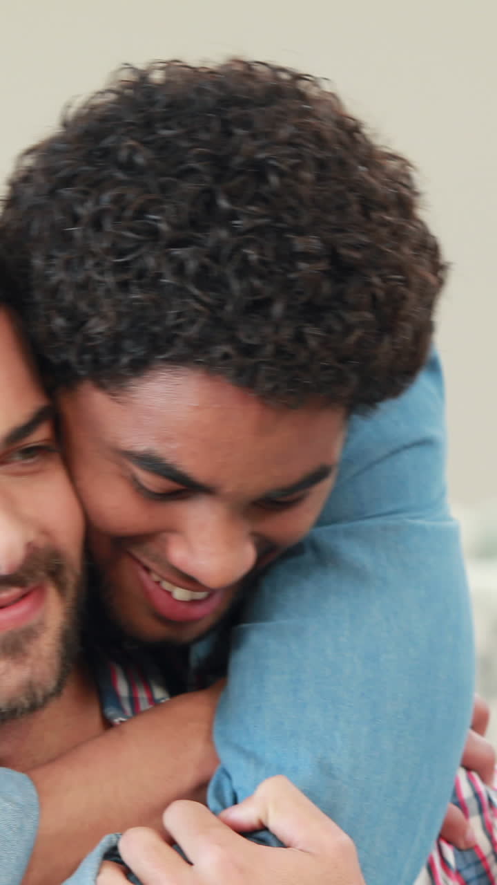 Coppia gay che si abbraccia sul divano