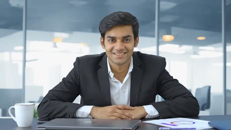 happy young indian businessman smiling