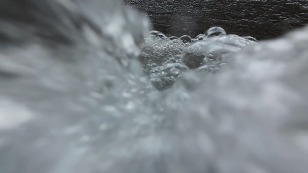 Water gently bubbles up, flowing over the camera and creating a serene atmosphere
