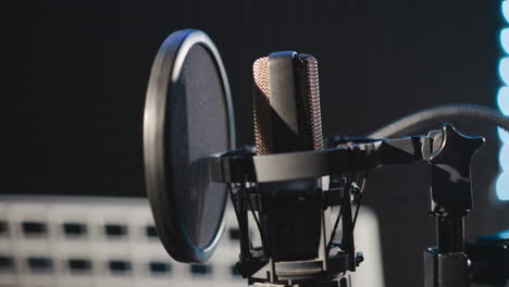 microphone in music recording studio closeup. modern mic with filter on stand in sound insulated room. audio equipment for broadcast translation