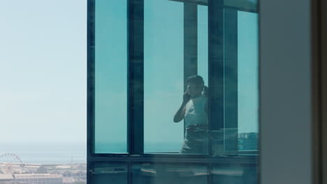 asian-business-woman-using-smartphone-talking-to-client-negotiating-corporate-deal-female-consultant-for-sales-company-having-phone-call-working-in-office-looking-out-window-at-city