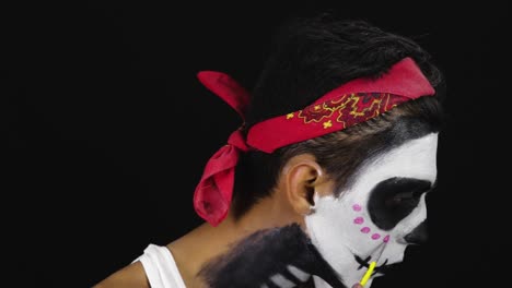 model putting on makeup for the day of the dead photoshoot