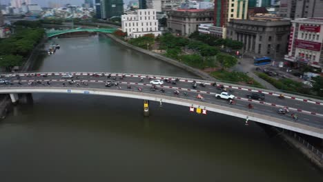 one of 13 drone shots of khanh hoi bridge which crosses the tau hu canal connecting districts 1 and 4 in ho chi minh city. 4k video in clear morning light with rush hour traffic on this  curved bridge