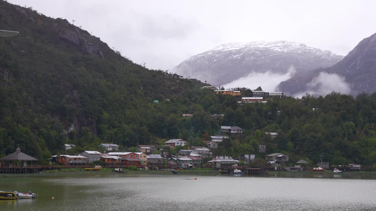 Scenic Village by a Fjord with Misty Mountains