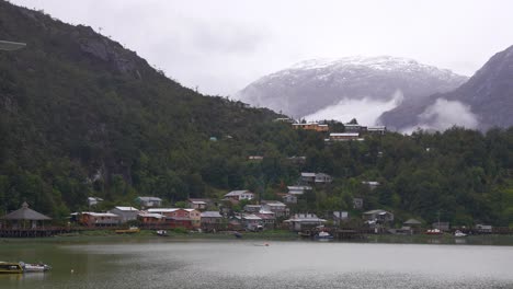 scenic village by a fjord with misty mountains