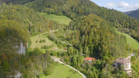 a drone shot of mountain road valleys forest trees hills at eisenkappel-vellach, austria