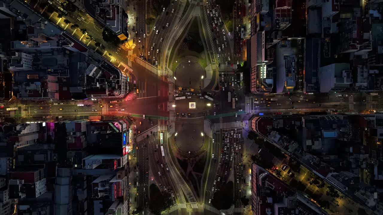 Aerial hyperlapse of Obelisk and 9 de Julio Avenue at night in Buenos Aires Argentina, city lights and urban life
