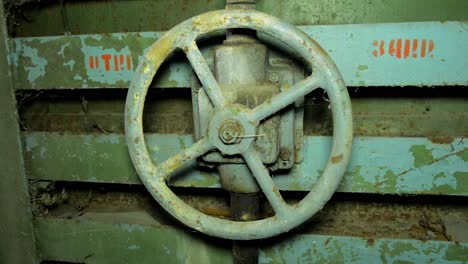 old steel door lock inside the concrete bomb shelter to hide civil people, an underground apocalypse bunker built in old coastal fortification, medium handheld closeup shot