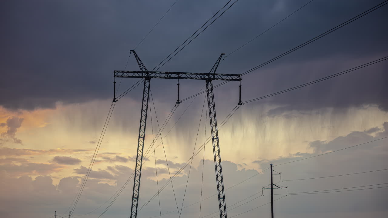 Timelapse shot of dark rain clouds moving over electric power lines during evening time
