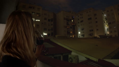 Woman-standing-with-a-glass-of-wine