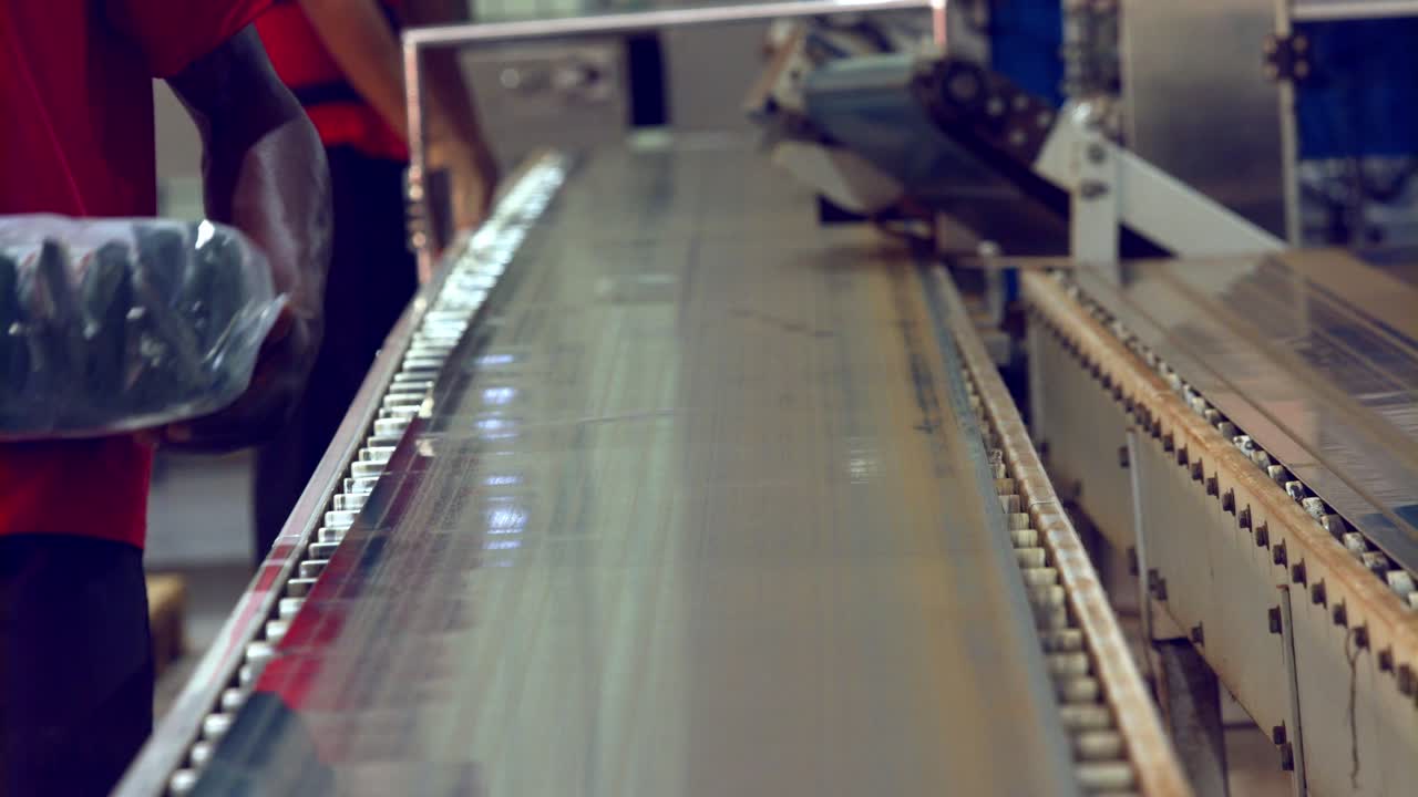 공장 컨베이어 벨트에서 커피 원두 묶음을 내리기