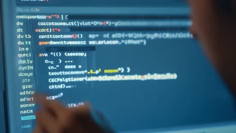 a man sitting in front of a computer, coding