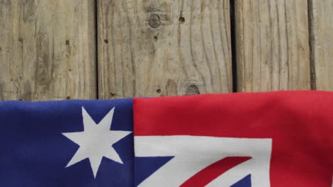 crumpled australian flag with stars and stripes lying on wooden background