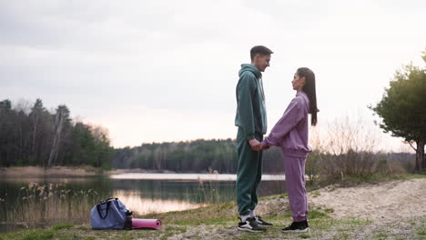 couple holding hands in the forest