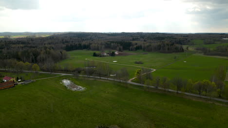 Drone-aerial-orbit-over-scenic-rural-countryside-with-farmhouse-and-solar-panels