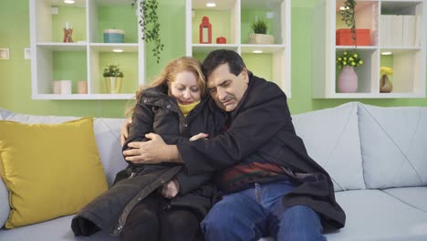 una pareja madura enferma que sufre del frío en casa se queja de las facturas altas.