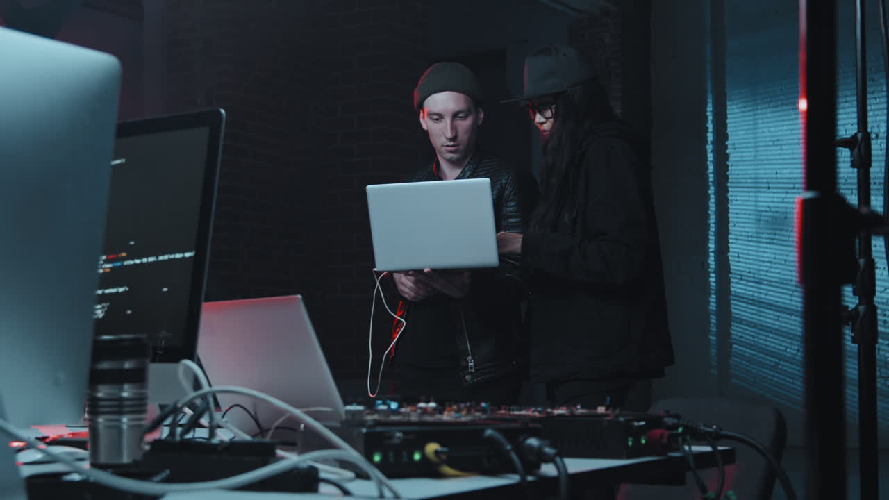 Hackers with Laptop in Dark Office