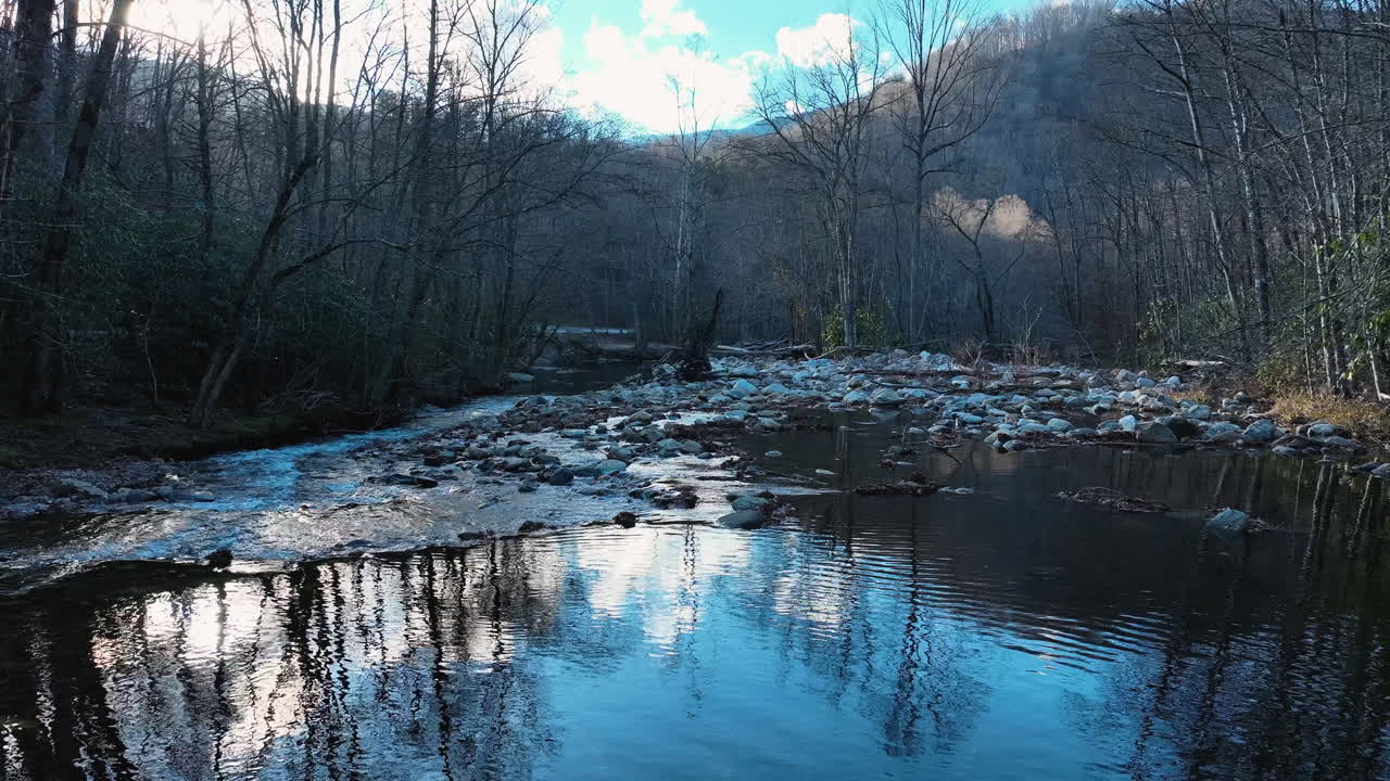 Drone-optagelse med tilt, der afslører vandet midt i en strøm i Blue Ridge Mountains i Waynesville, North Carolina
