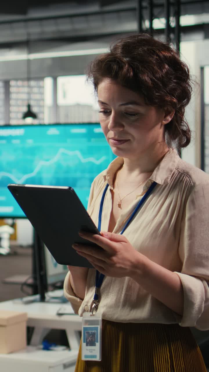 Vertical Video Woman business consultant examines charts and icons on tablet