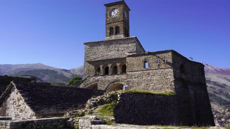 beautiful clock tower of citadel with stone high walls in gjirokaster, albania