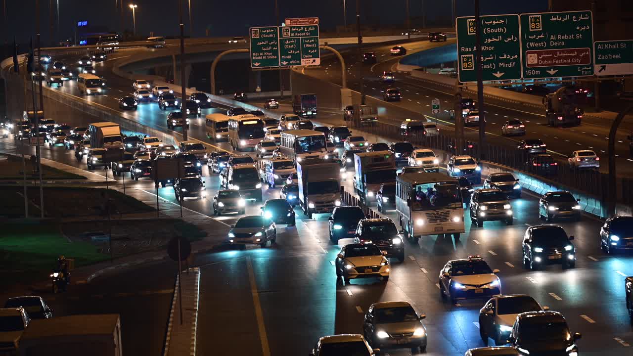 Slow-moving evening traffic on Nadd Al Hamar Road in Dubai, heading towards Sharjah, United Arab Emirates.