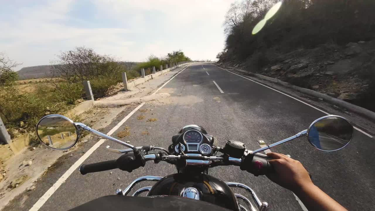 POV shot of motor bike riding on a elevated road through hills of gwalior in madhya pradesh india