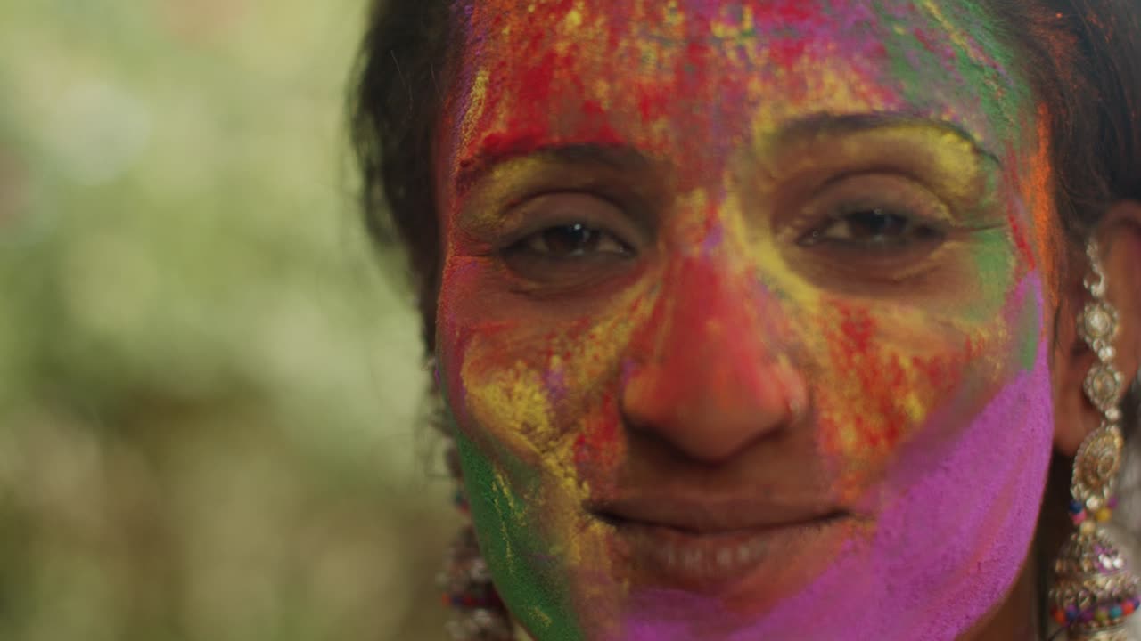 Primo piano di donne indiane con il viso imbrattato di vivaci colori Holi