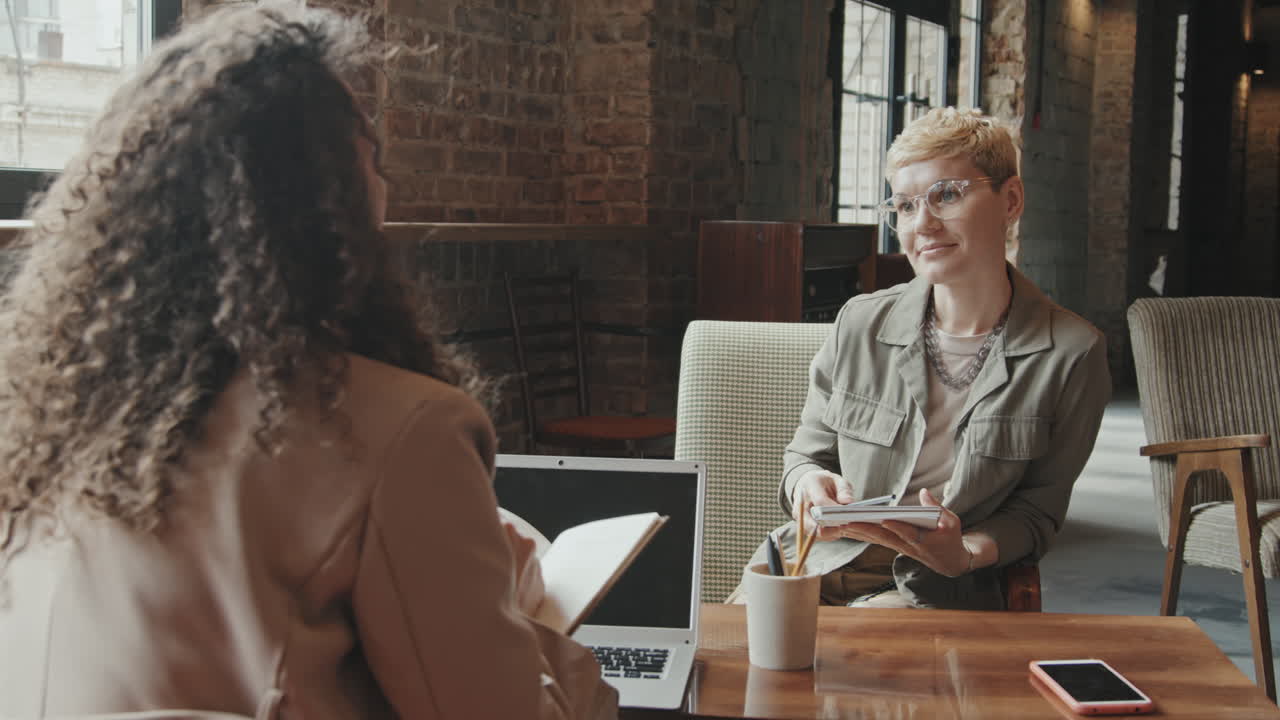 Business Women Talking at Coworking Space