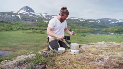 hiker preparing equipment for cooking at the campsite