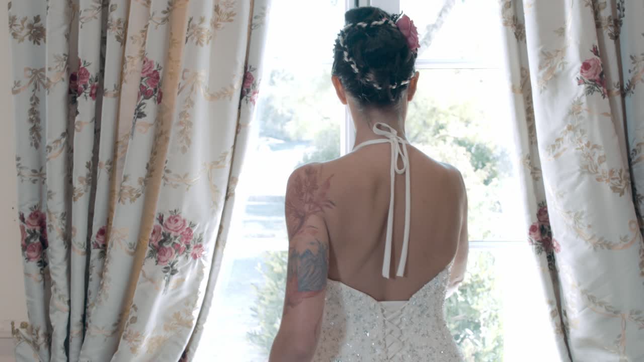 Slow motion shot of a bride walking and opening the doors at the reception