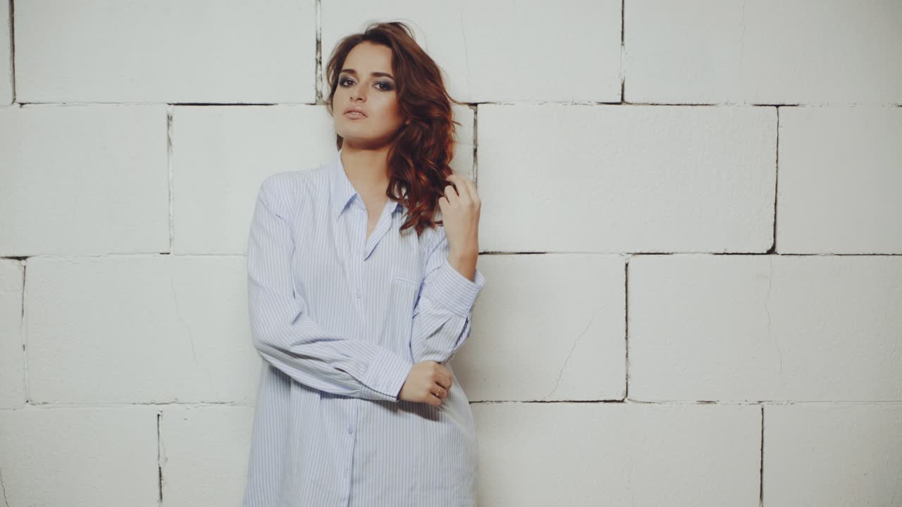 Portrait of model woman. Female model in stylish clothes posing in studio