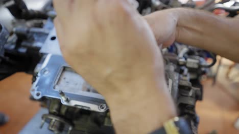 close-up of a mechanic checking the timing belt chain in a vehicle