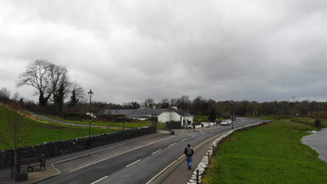 Aerial---Main-road-of-a-downtown-nearby-the-river-and-the-cafe-on-the-roadside