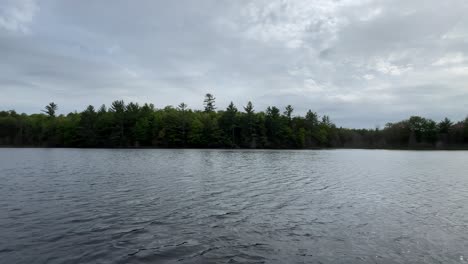 Middle-Of-Small-Lake-With-Trees-on-Coast-Cloudy-Day