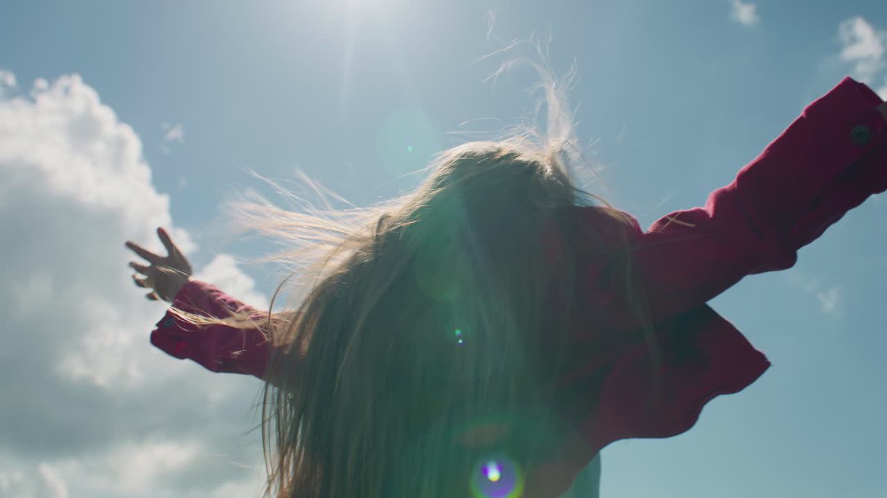 Young Girl Moves Long Hair Young Girl Moves Long Hair on Beautiful Greenery Hill Enjoying Flows of Warm Wind Watching at Amazing Landscape Spending Leisure Time Outdoor back View Slow Motion
