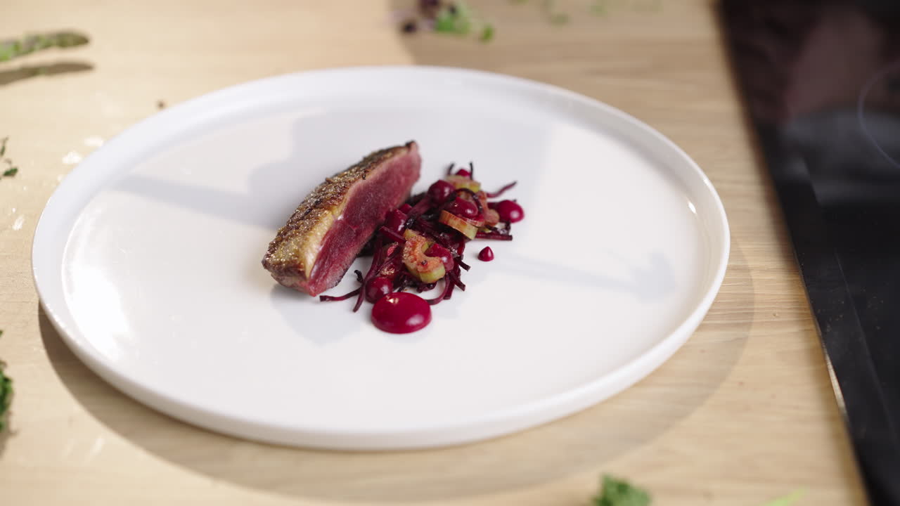 Gourmet duck dish being plated