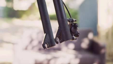 person dismantling damaged bicycle wheel