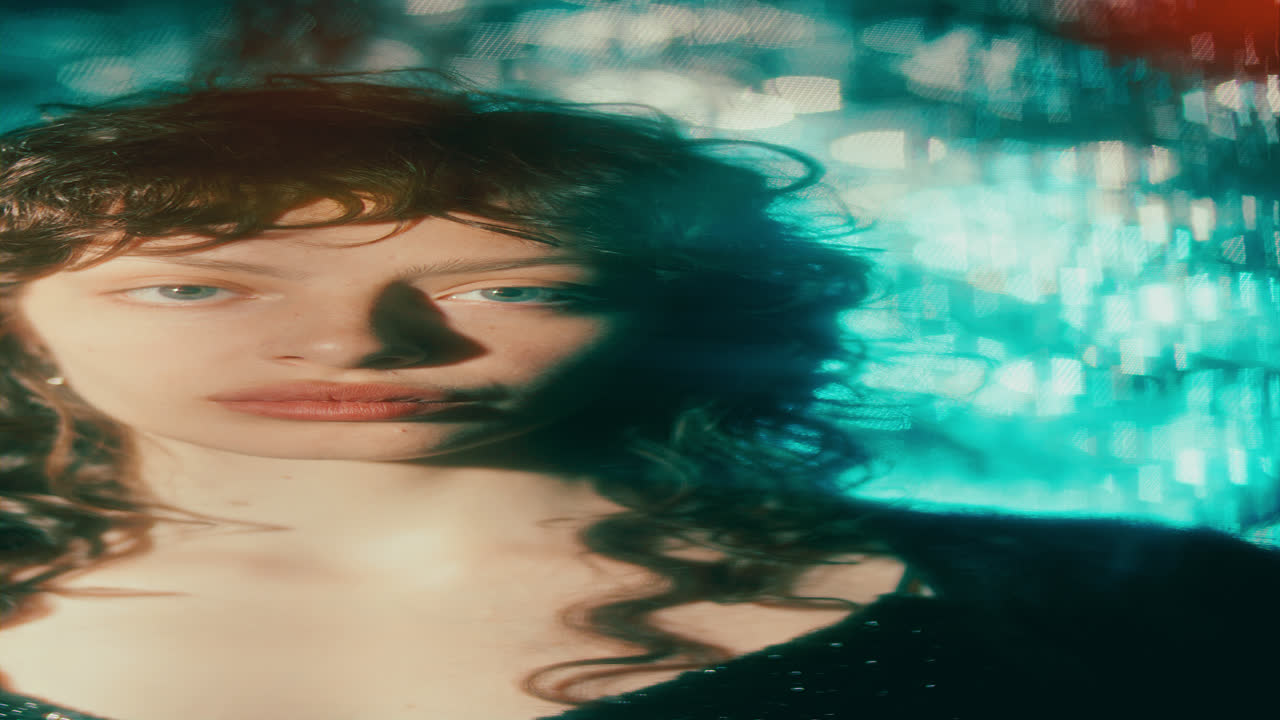 Vertical Portrait of Young Woman behind Flickering Bokeh Lights