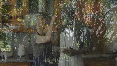 cooking at home, elderly woman with window reflection showing trees outside