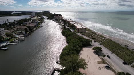 A-stunning-view-can-be-observed-from-an-elevated-position,-where-a-body-of-water-flows-parallel-to-two-roads