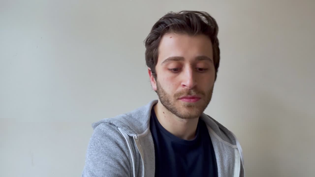 Young Male University Student Asking Question During Video Lecture