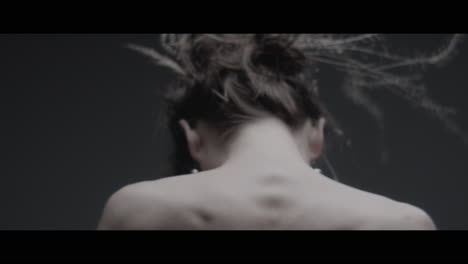 a woman dressed as mother nature moves slowly in a dance-like motion